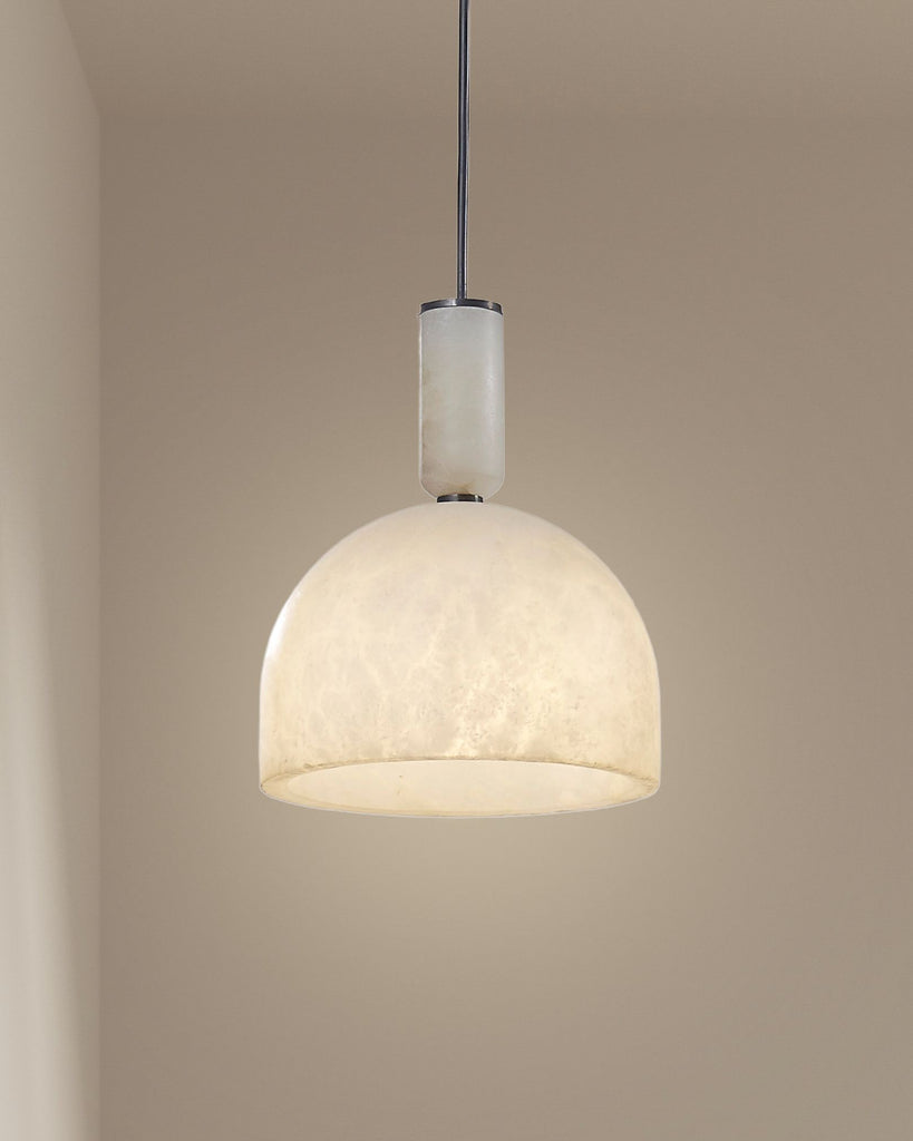 Seren alabaster pendant light with dome shade hanging in a minimalist interior